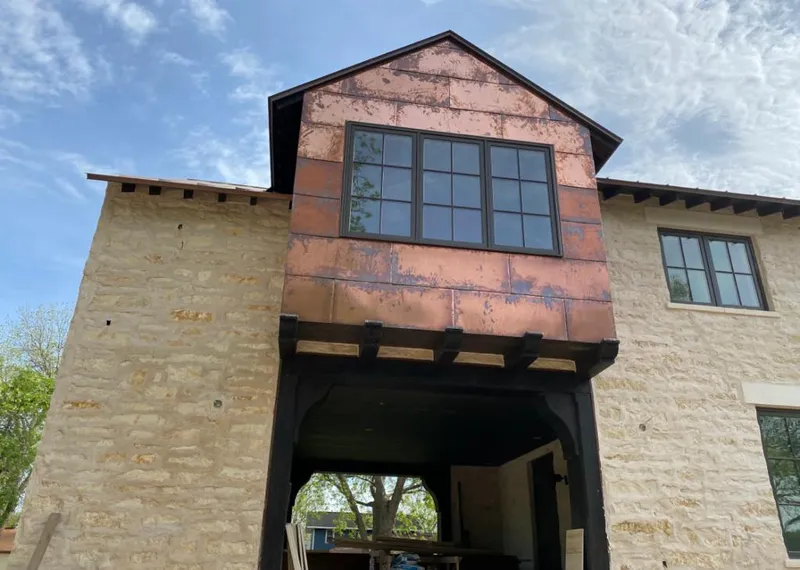 Copper metal panel facade on a stone building for Roof Repair in Zephyrhills West
