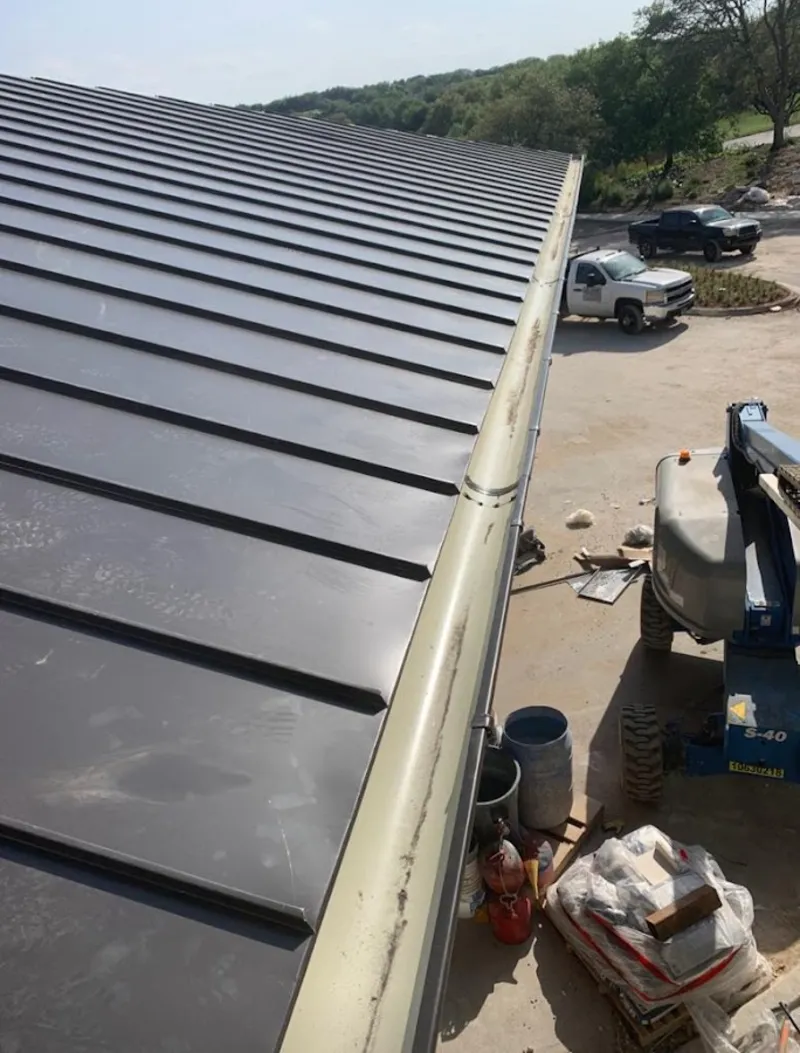 Standing seam panel and gutter detail on a metal roofing jobsite in Zephyrhills West
